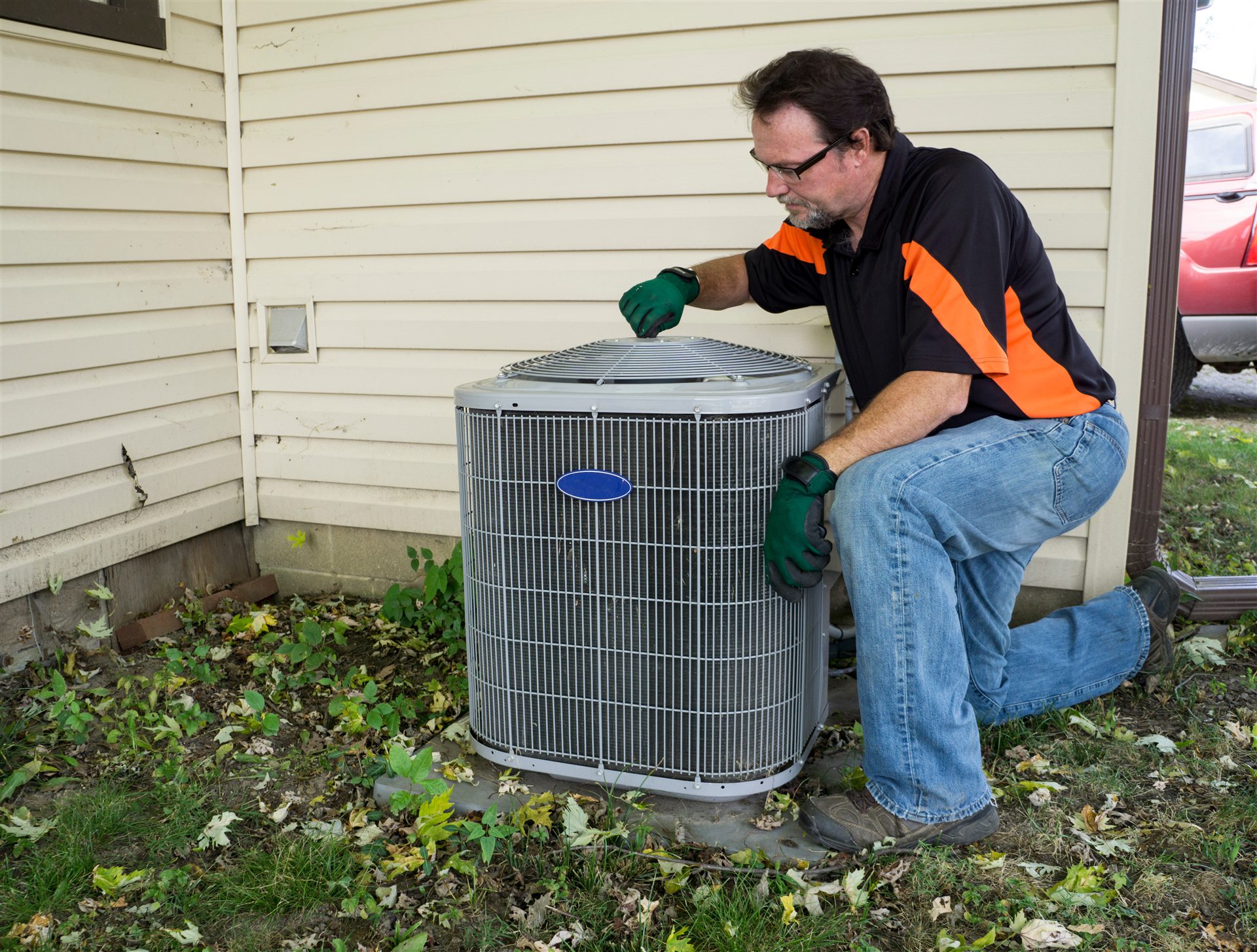 Miller Services technician servicing an AC unit